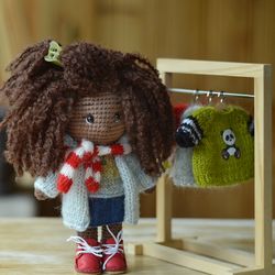 Crochet doll with set of clothes and rack for clothes