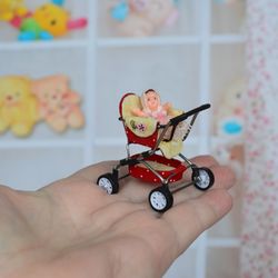 Miniature toy doll stroller in 1/24 scale. Complete with baby doll. Red handmade stroller.