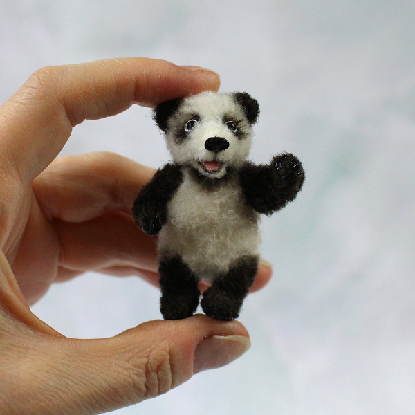 tiny-panda-doll-in-hand.jpg