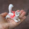 Realistic-mini-toy-white-cat-in-hand.jpg