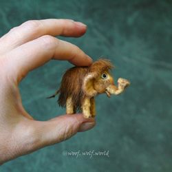 Tiny Mammoth Baby. Miniature figurine of a small mammoth