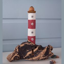 Lighthouse on a wooden base made of driftwood in a nautical style, original interior decor and a gift for any holiday