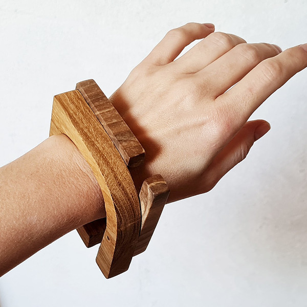 two wooden bracelets on hand 1