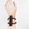 geometric wooden bracelet with metal elements on the arm 2