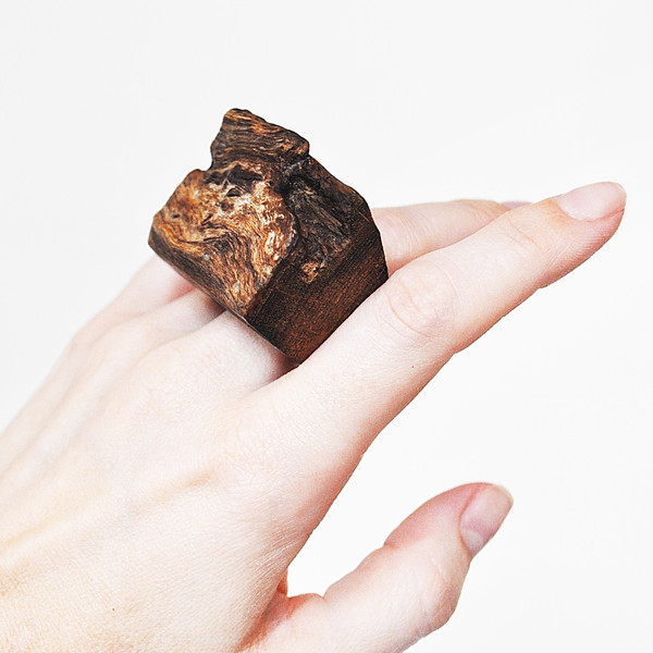large wooden ring with a live edge on the hand 3