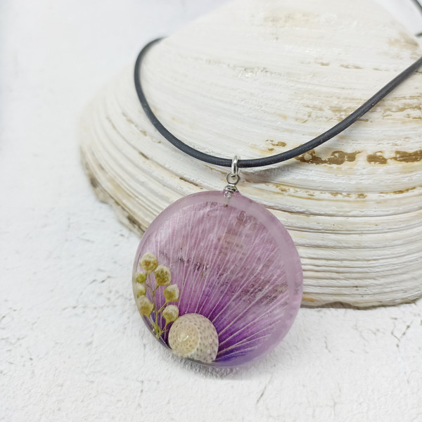 purple necklace with a snail.jpeg