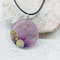 purple necklace with a snail_.jpeg