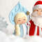 Felt Snow maiden and grandfather Frost toys against the background of snow and snowflakes