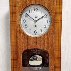 vintage pendulum wall clock. soviet mechanical hanging clock
