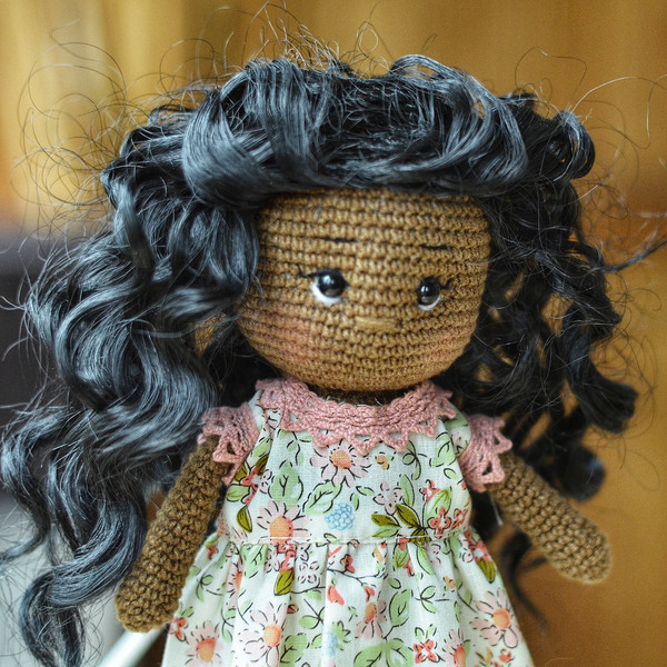 African doll with black curly hair