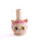 wooden cat whistle with a light pink headband