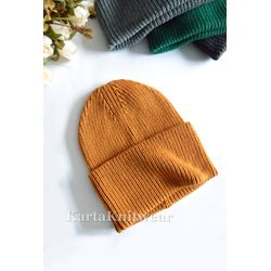 Hat knitted mustard orange color. Warm knit merino wool hat.