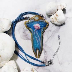 Blue necklace with pink jellyfish, with moonstone.