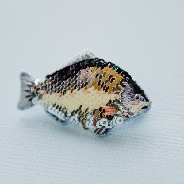 close up embroidered fish brooch