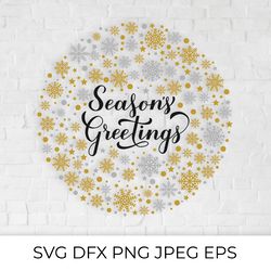 seasons greetings calligraphy hand lettering with gold and silver snowflakes, stars and dots