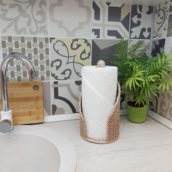 Beige paper towel holder for a gray kitchen. Wicker handmade kitchen roll holder.