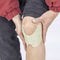 Natural knee pain relief patch being applied smoothly