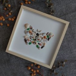 Butterfly sea glass and shells. Mosaic of shells and sea glass for wall decor. Small butterfly on white.