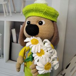 Order. Crocheted puppy. Cute stuffed toy with flowers.
