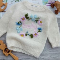 Personalized soft winter knitted sweater with embroidered flowers and baby's name. Handmade knitted pullover for a girl