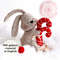 Felt toys - bunny with Christmas red candies on the snow