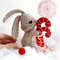 Felt toys - bunny with Christmas red candies on the snow