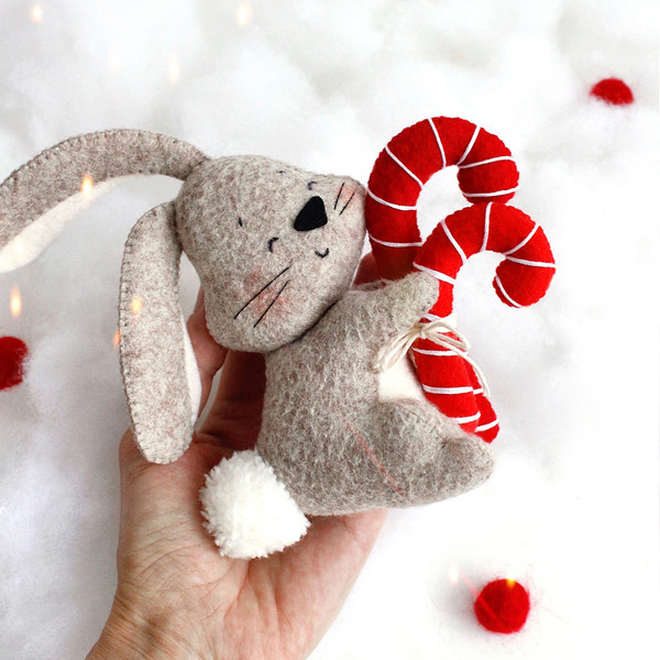 Felt toys - bunny with Christmas red candies in the author's hand