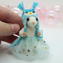 Miniature needle felted mouse in a blue owl hat and a tutu