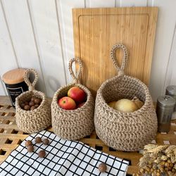 Set of hanging wall baskets for vegetables, fruits. Crochet jute basket, potato onion and garlic storage.