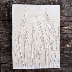 Wall art spikelets. The first spring plants depicted in a botanical bas-relief
