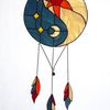 Stained glass Yin Yang dreamcatcher in art deco style in blue and yellow with sun and moon symbols on a white background.jpg