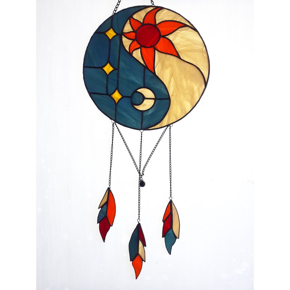 Stained glass Yin Yang dreamcatcher in art deco style in blue and yellow with sun and moon symbols on a white background.jpg