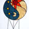 Stained glass Yin Yang suncatcher in art deco style in blue and yellow with sun and moon symbols on a white background.jpg
