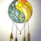 Stained glass Yin Yang dreamcatcher in art deco style in blue and yellow with sun and moon symbols on a white background.jpg