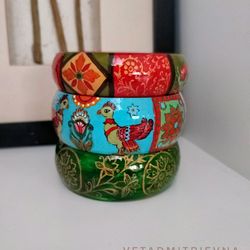 a set of wooden painted outlandish bracelets
