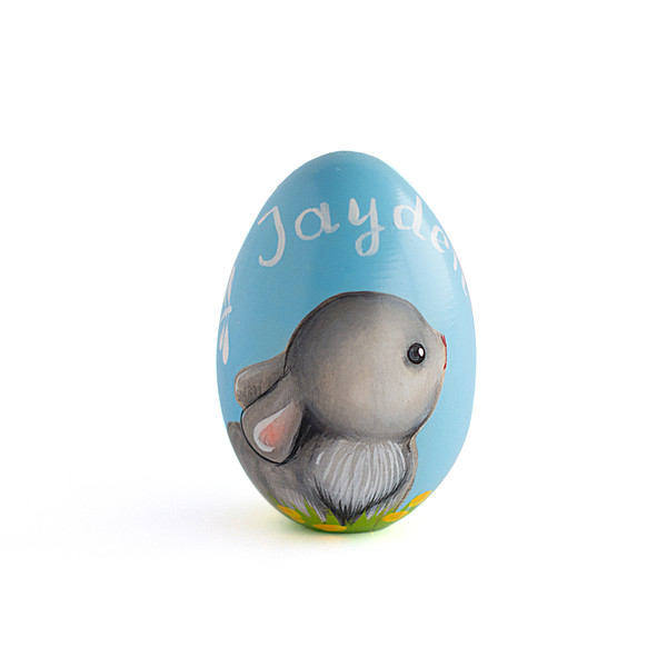 Wooden blue egg with a painted bunny and a personal name