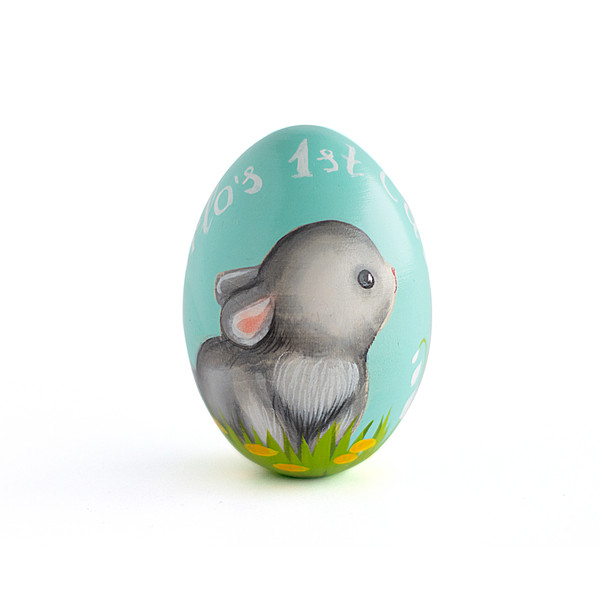 light turquoise wooden egg with a cute bunny and a personalized inscription