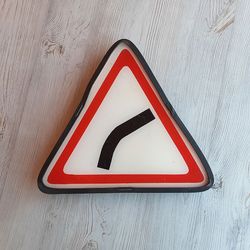 Gentle curve ahead Russian traffic road sign vintage - triangle Soviet traffic sign outdoor