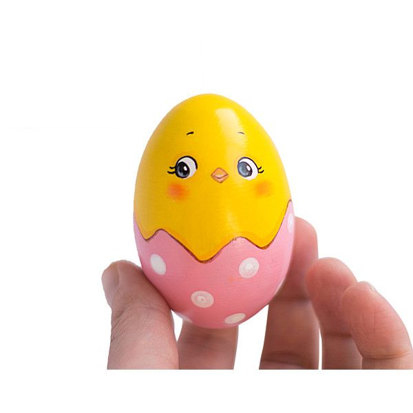 wooden egg hatched chick in a light pink shell