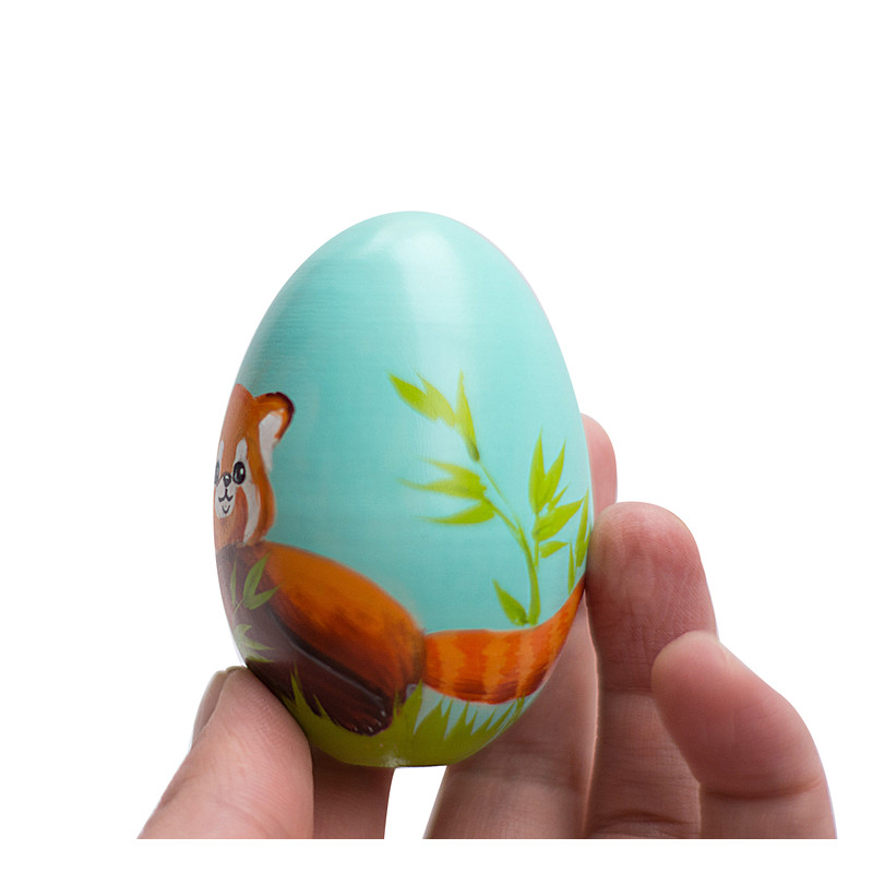 cute red panda on a painted wooden egg