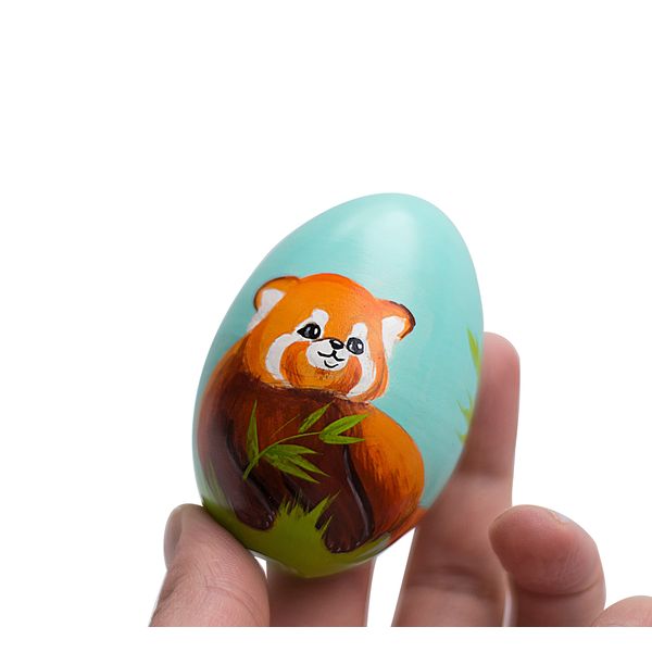 cute red panda on a painted wooden egg