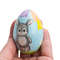 cute bunny with balloons on painted wooden egg