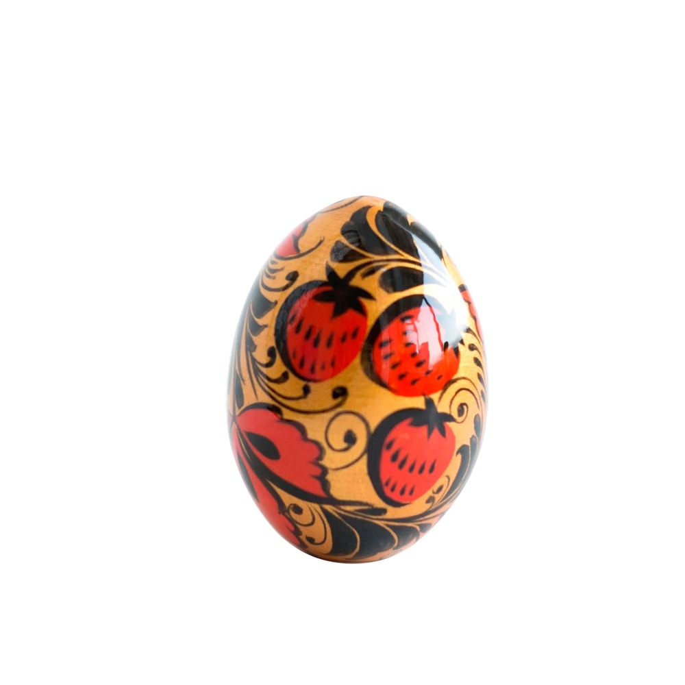Russian Easter wooden painted egg Altai Khokhloma strawberries on a golden background