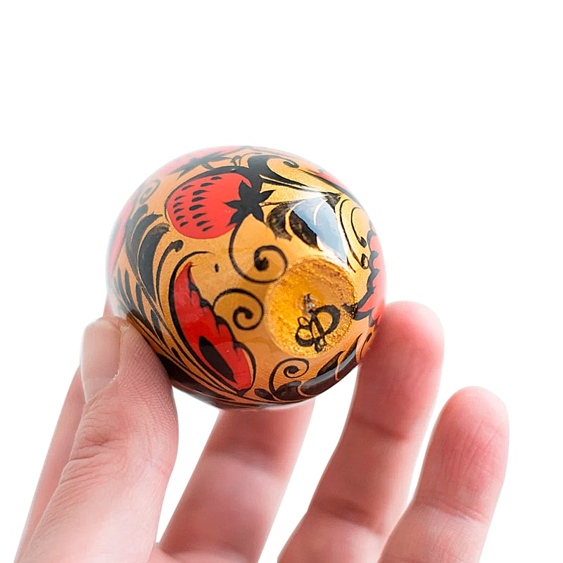 Russian Easter wooden painted egg Altai Khokhloma strawberries on a golden background