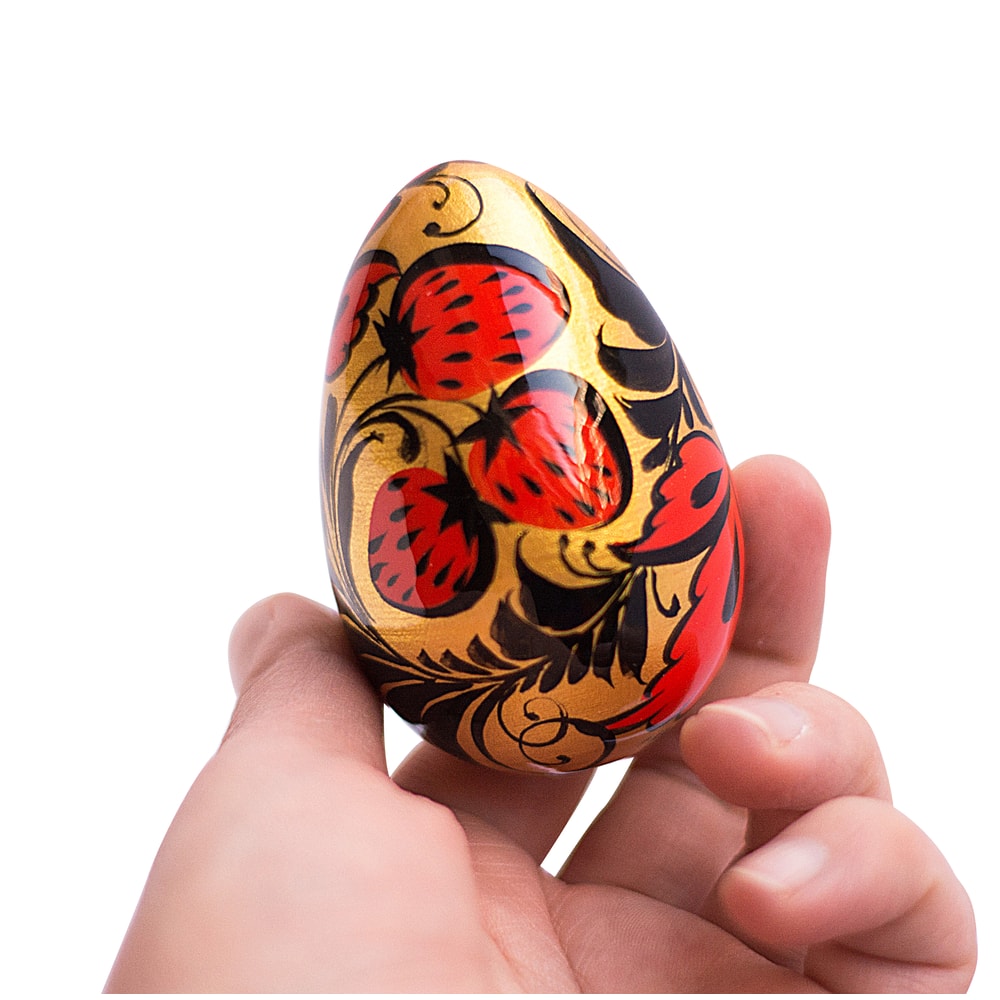 Russian Easter wooden painted egg Altai Khokhloma strawberries on a golden background