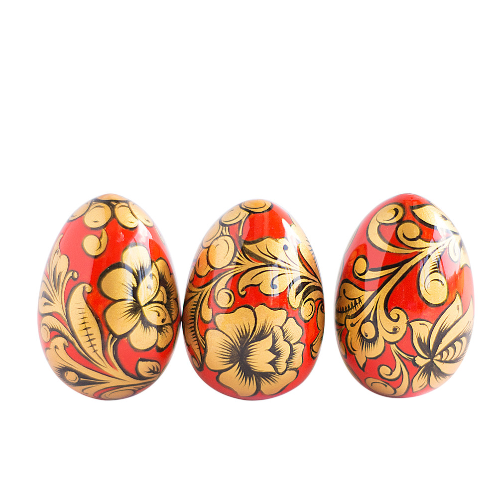 Russian painted egg Khokhloma gold flowers on a red background