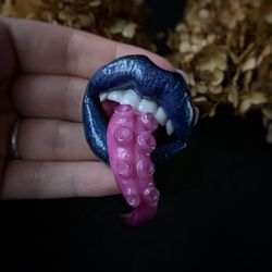 Lip brooch with octopus tentacle