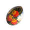 russian easter wooden egg hand painted red strawberry and golden and green leaves on black background