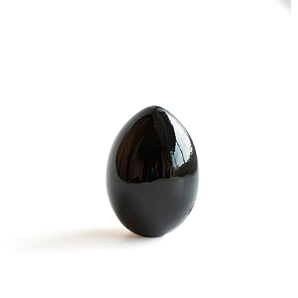 wooden painted black egg  penguin from behind