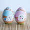 Easter wooden painted blue and pink eggs with a baby bunny